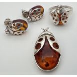 A silver and cognac amber pendant, ring and matching earrings in the form of ladybirds. Ring and