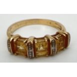 A 9ct yellow gold, citrine and diamond eternity style ring. 3 square cut citrine's separated by 4