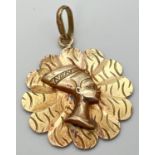 An 18ct yellow gold flower shaped pendant featuring Nefertiti. Bale stamped 750 and pendant tests as