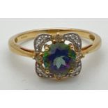 A 9ct gold, mystic topaz and diamond ring in a square shaped basket style setting. Central round cut