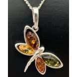 A 925 silver and amber pendant in the form of a butterfly on an 18" silver chain. Both pendant and