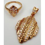 A 21ct gold plated pendant and matching ring set with clear stones. Both with pierced work Greek key