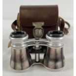 A pair of mother of pearl set opera glasses with a leather carry case.