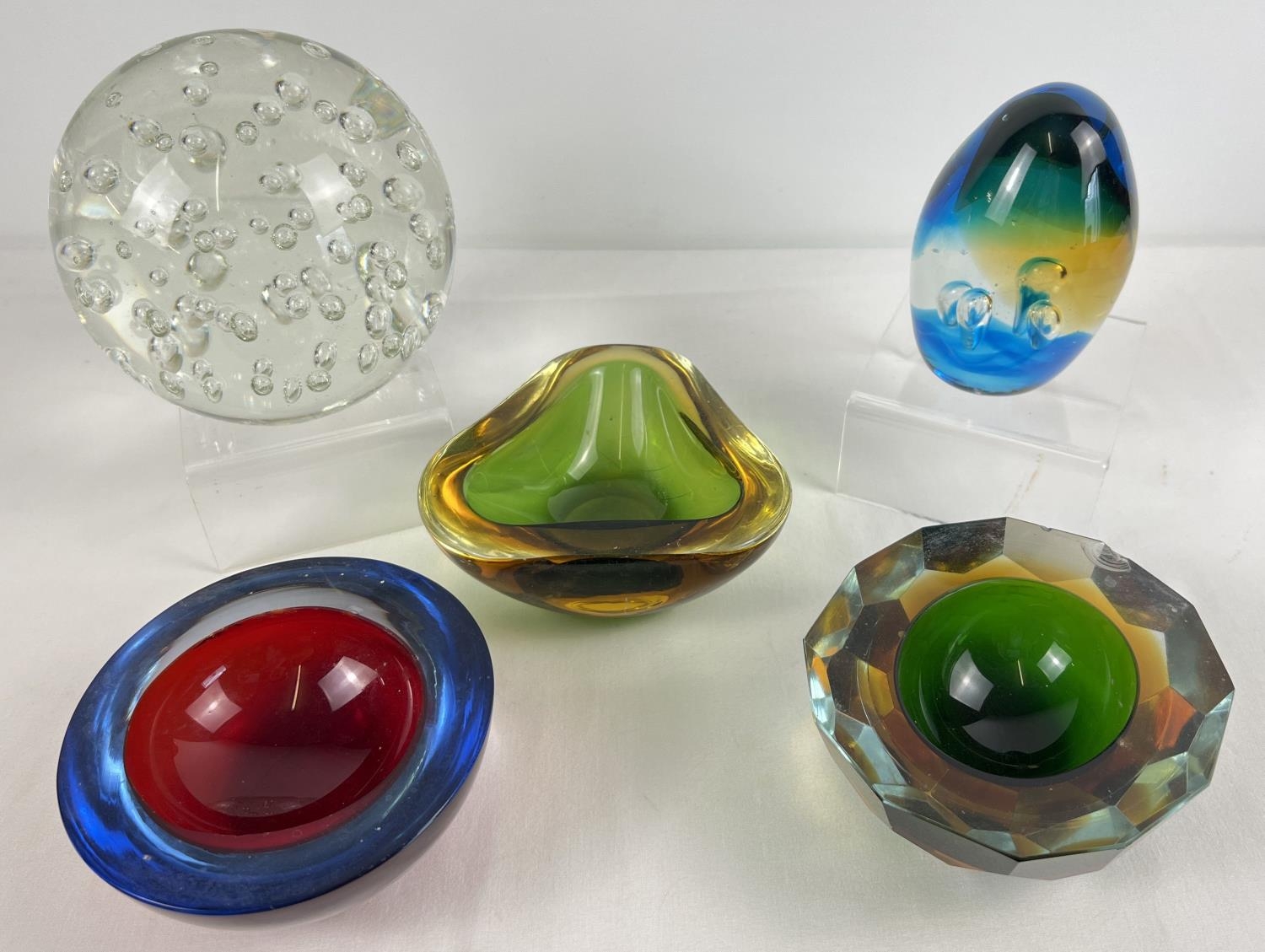 A small collection of retro art glass. To include a large clear glass ball paperweight, coloured