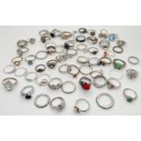 A collection of 60 assorted costume jewellery silver tone dress rings. In varying sizes and styles