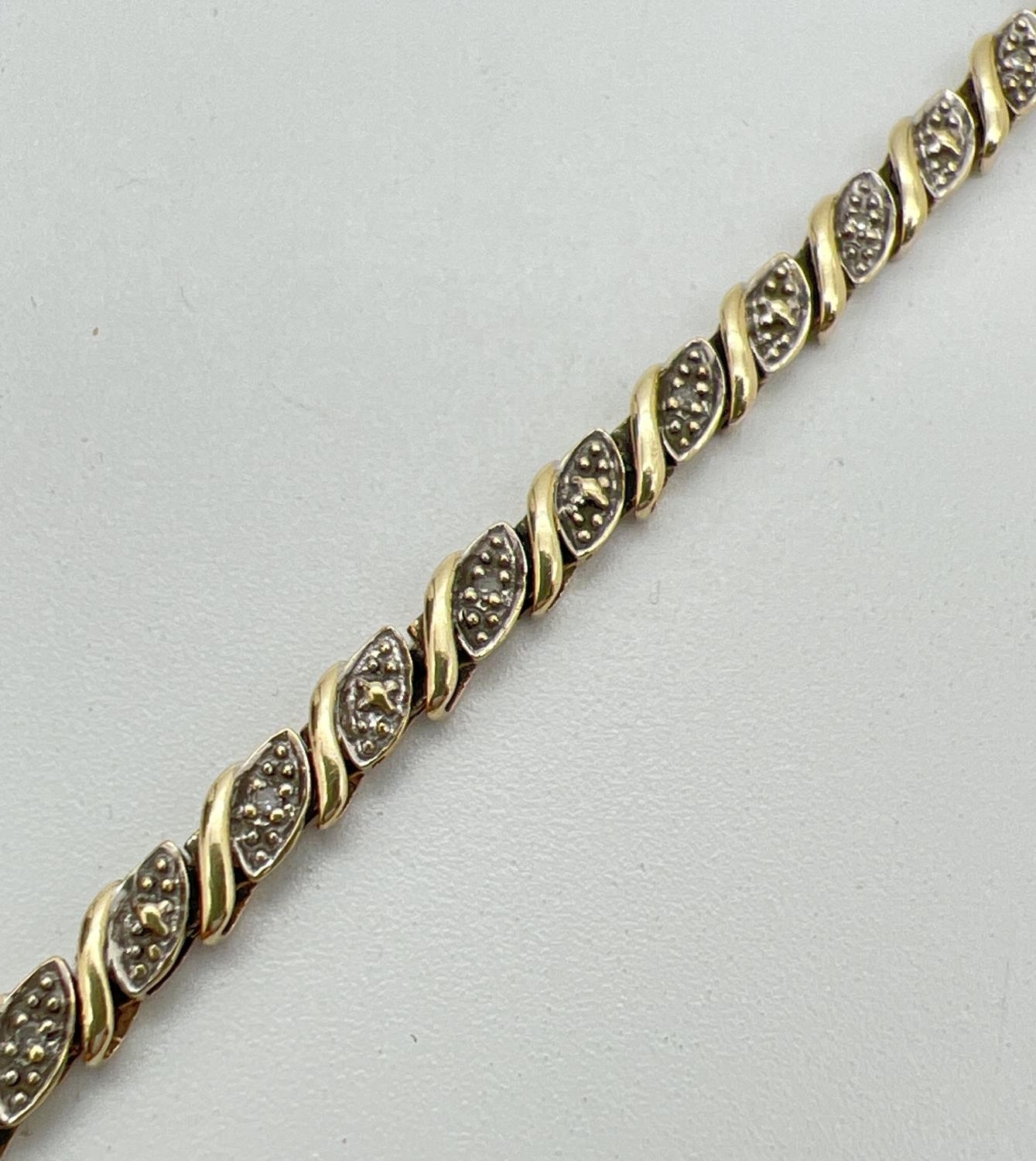 A 7.5 inch 9ct gold and diamond decorative bracelet. 30 small wave design panels, 15 set with a