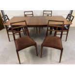 A mid century Afrormosia wood draw leaf extending dining table & 6 chairs, by Richard Hornby for