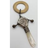 A vintage silver baby's rattle/teething ring with two small bells and mother of pearl handle.