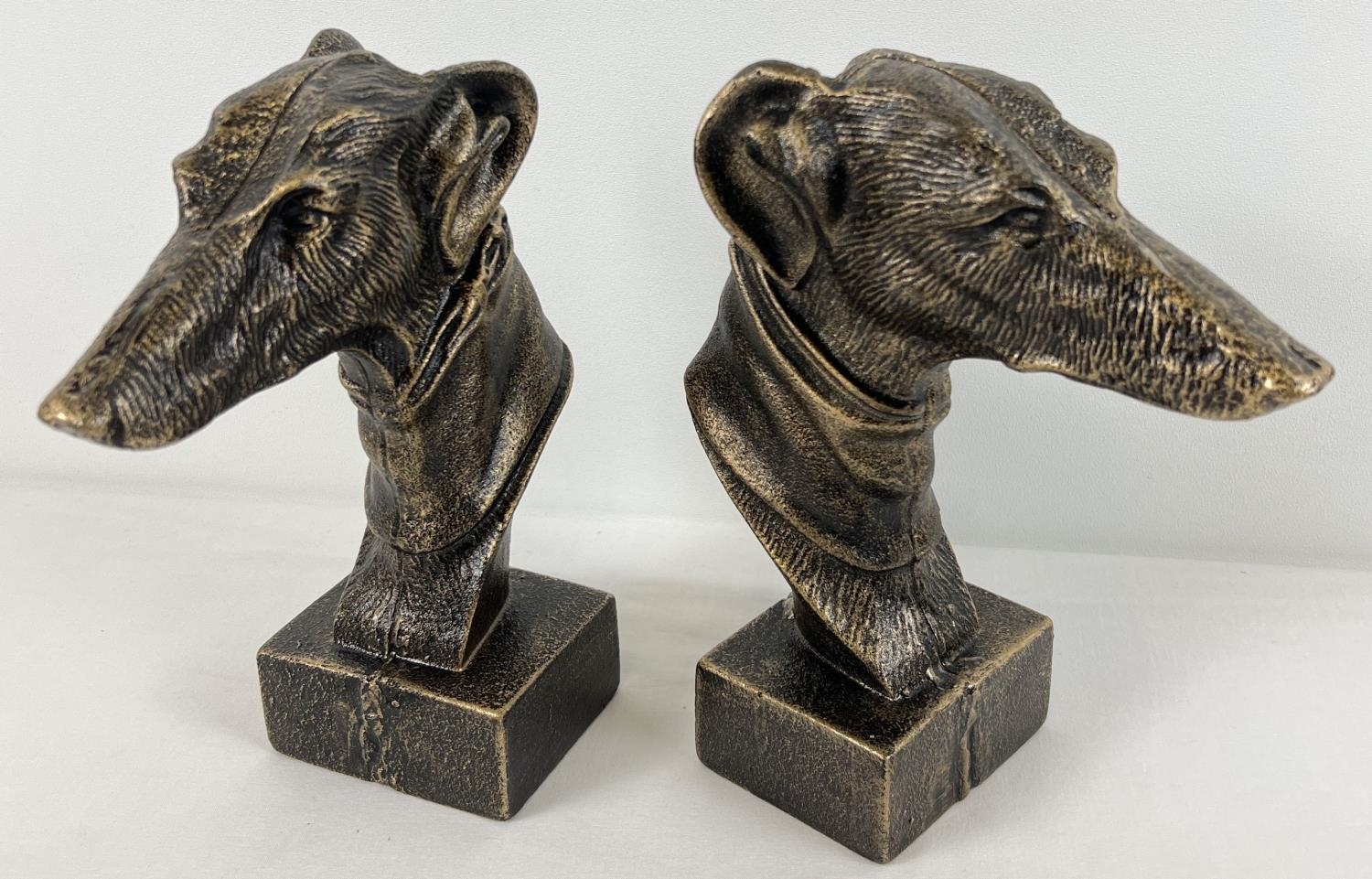 A pair of cast iron bronzed effect figures of greyhound heads. Approx. 22cm tall.