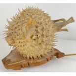 A vintage taxidermy Puffer Fish lamp. On wooden base in the shape of Mauritius with hand painted