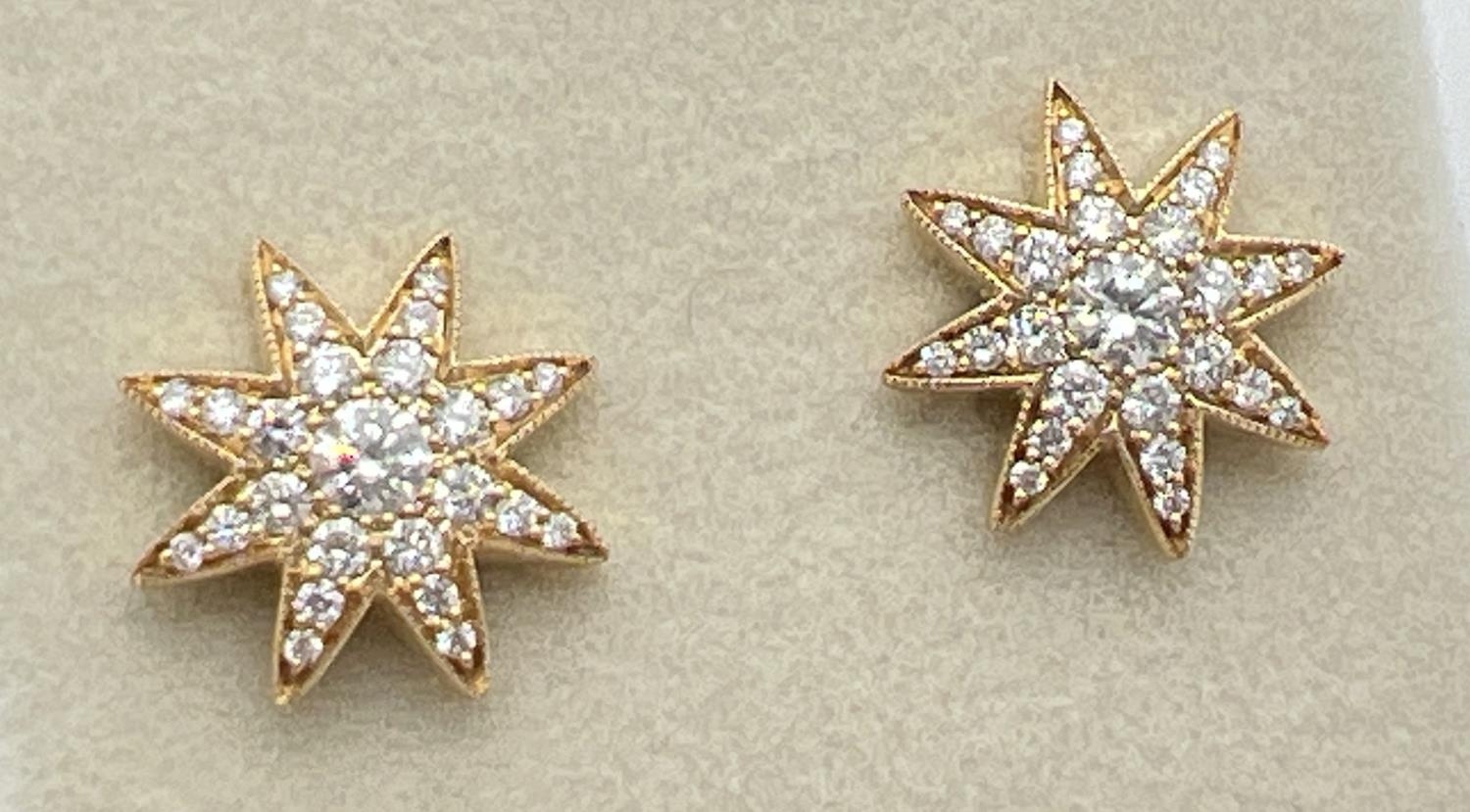 A pair of 18ct yellow gold diamond set star shaped stud earrings by Luke Stockley, London. Each