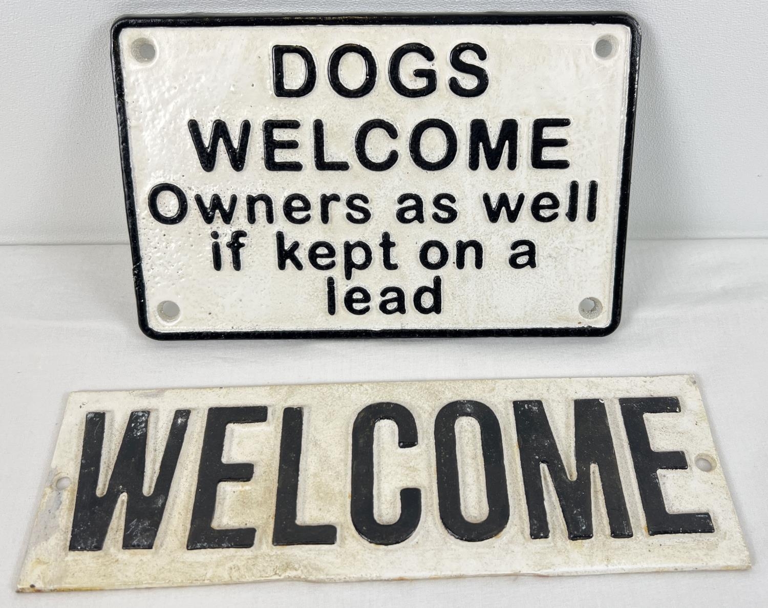 2 black & white painted cast iron Welcome wall plaques with holes for fixing. Dog sign approx. 12.