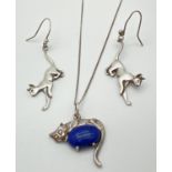 A pair of white metal cat shaped, drop style earrings together with a cat pendant set with a blue