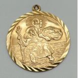 A 9ct gold double-sided circular St. Christopher pendant with fixed hanging bale. Reverse depicts