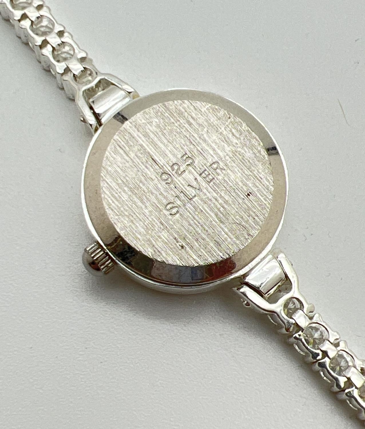 A modern silver cased ladies quartz wristwatch with mother of pearl face and clear stone set - Image 4 of 4