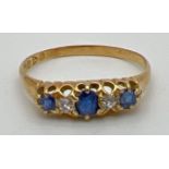 A vintage gypsy style 18ct gold sapphire and diamond set ring. Claw set mount with 3 sapphires and