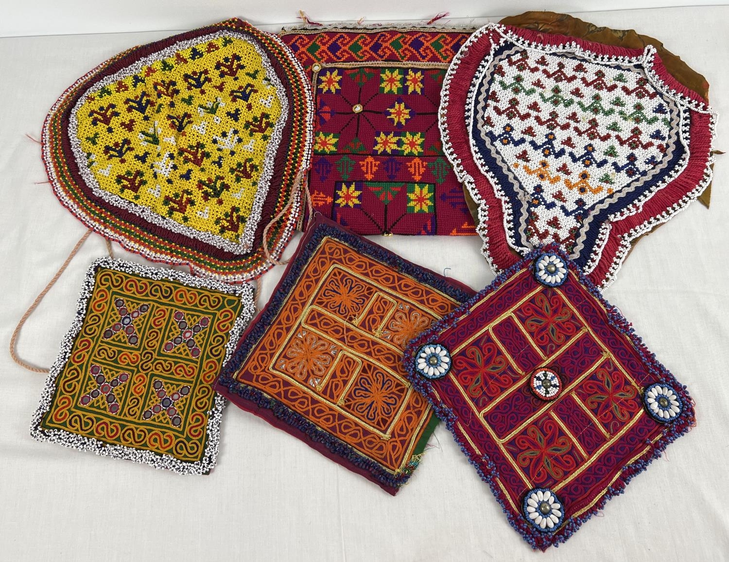 A collection of 6 vintage Central Asian heavily beaded and embroidered fabric panels. In varying