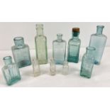 A collection of 10 assorted antique glass bottles to include advertising. Examples include: Eiffel