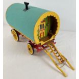 A painted wooden dome topped model of a Gypsy caravan with hand painted and sticker detail. Green