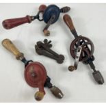 3 vintage wooden handled hand drill together with a small vice. Drills include examples by Talco and