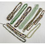 A collection of assorted vintage glass beaded necklaces.