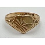 A vintage 9ct gold heart shaped signet ring with sun-ray decoration and small empty cartouche.