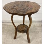 A vintage Oriental style occasional table with carving of foliate design to top and undershelf.