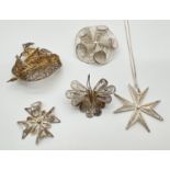 A collection of silver and white metal filigree jewellery brooches and pendants. To include