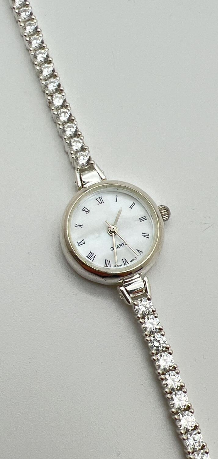 A modern silver cased ladies quartz wristwatch with mother of pearl face and clear stone set - Image 2 of 4