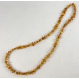 A 48" honey and butterscotch amber rectangular and circular bead necklace. Total weight approx.