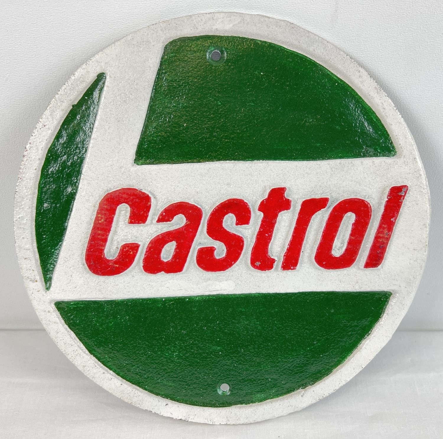 A circular shaped painted cast iron wall plaque for Castrol Oils. In green, white & red, with fixing