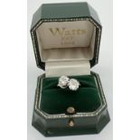 A vintage platinum and 2ct diamond twist design ring. 2 round brilliant cut diamonds, 1ct each, in a