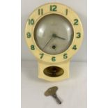 A 1940/50's cream bakelite cased Smiths Enfield kitchen clock with pendulum. Green numerals ( re-