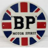 A BP Motor Spirit circular shaped painted cast iron wall plaque. In red, white blue & black. Approx.