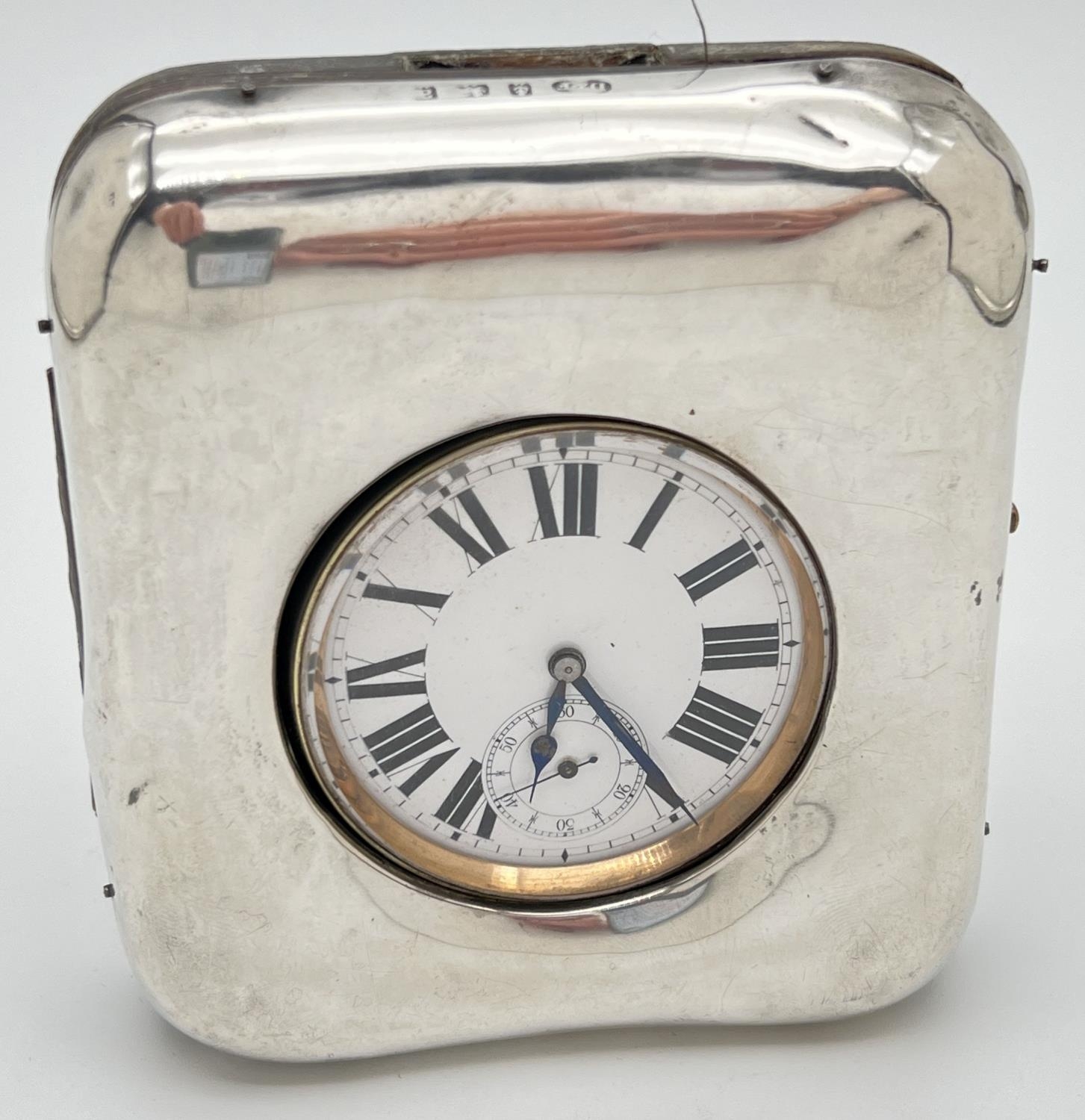 A late Victorian silver covered pocket watch stand with an Argentan Goliath pocket watch. Silver