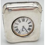 A late Victorian silver covered pocket watch stand with an Argentan Goliath pocket watch. Silver