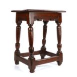 A good Charles I oak joint stool, circa 1630, having a top with ovolo moulded edge, bicuspid