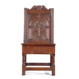 A rare Charles I box-seat closed-back side chair, Lancashire, circa 1630-40, the well-carved back