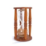 19th Century pine hour glass/sand timer, the circular top above four turned columns enclosing the