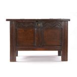 A small Charles II oak coffer, Devon, circa 1660, having a twin-panelled lid and front, and a