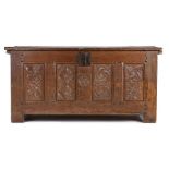 An impressive early 16th Century oak coffer, Normandy, circa 1500, having a deep plank hinged top,