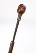 19th Century Folk Art sword stick, the treen human carved head above the blue steel blade and
