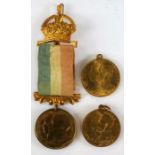 Three George V commemorative coronation medals, one with tricolour ribbon and crown pin, one 3.5cm