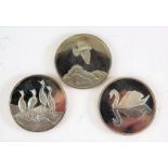 Three Peter Scott British birds silver medallions, depicting sky lark, mute swan and shag, all