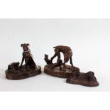 Three various bronzed dog ornaments, the two larger indistinctly signed to base and dated 1974,