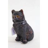 Bretby pottery cat, with a black glaze and modelled in a seated position, 17cm high