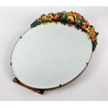 Large Barbola easel mirror, mounted with a colourful floral garland above an oval bevelled glass