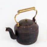 Large cast iron tea pot with brass handle, 29cm wide
