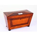 Regency mahogany tea caddy, of sarcophagus form, the inlaid hinged lid enclosing a two compartment