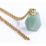 Jade pendant on a yellow metal chain